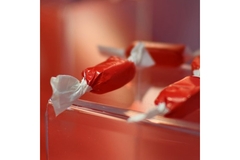 Close-up of red and white wrapped candies showcasing wax-free recyclable packaging